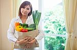 Young Woman With Vegetables In Shopping Bag Stock Photo