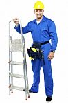 Young Worker Holding Step Ladder Stock Photo