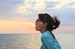 Younger Asian Woman Open Mouth With Sun Set Sky Background Stock Photo